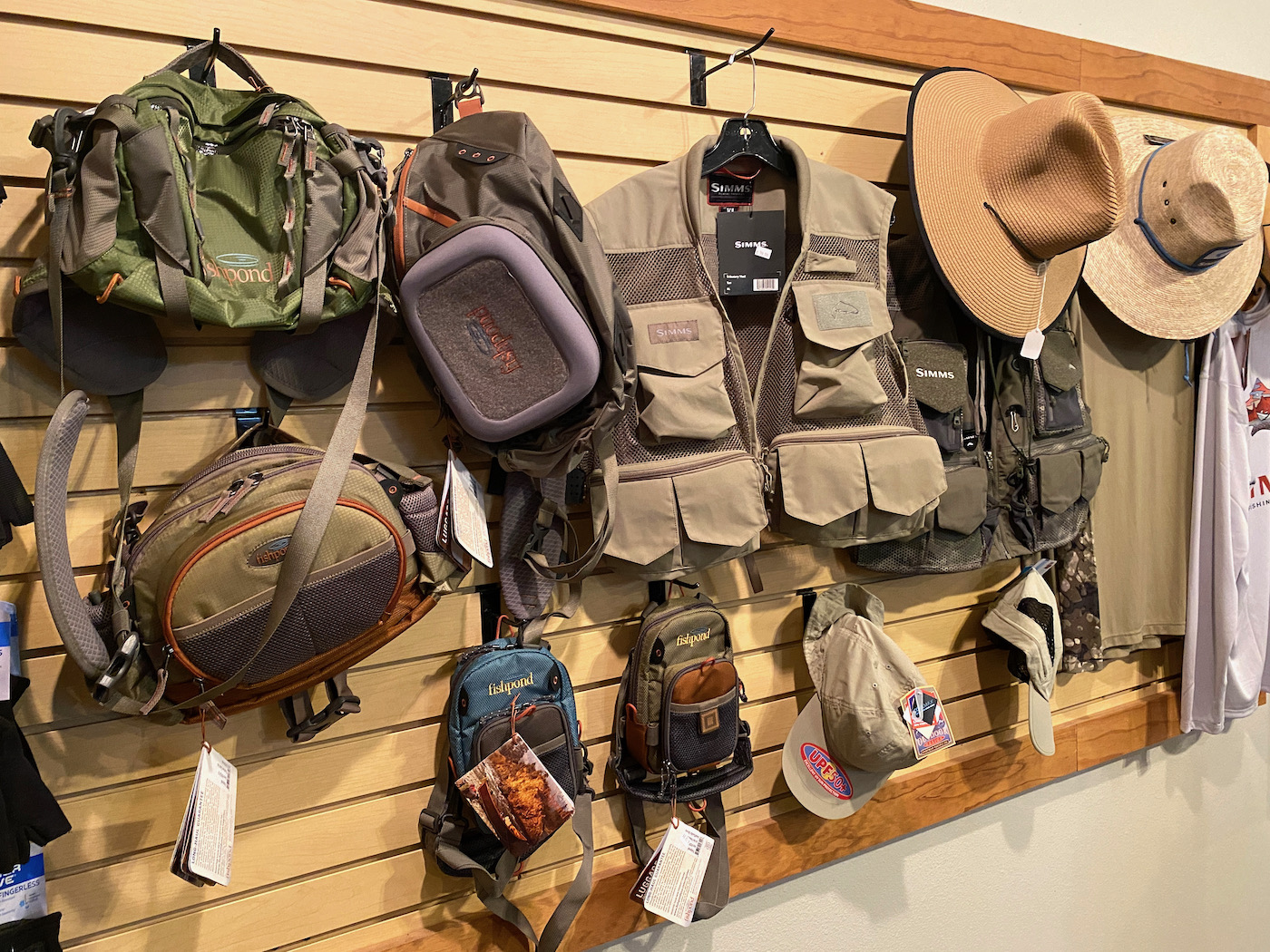 Fly fishing packs and hats in a fly fishing shop