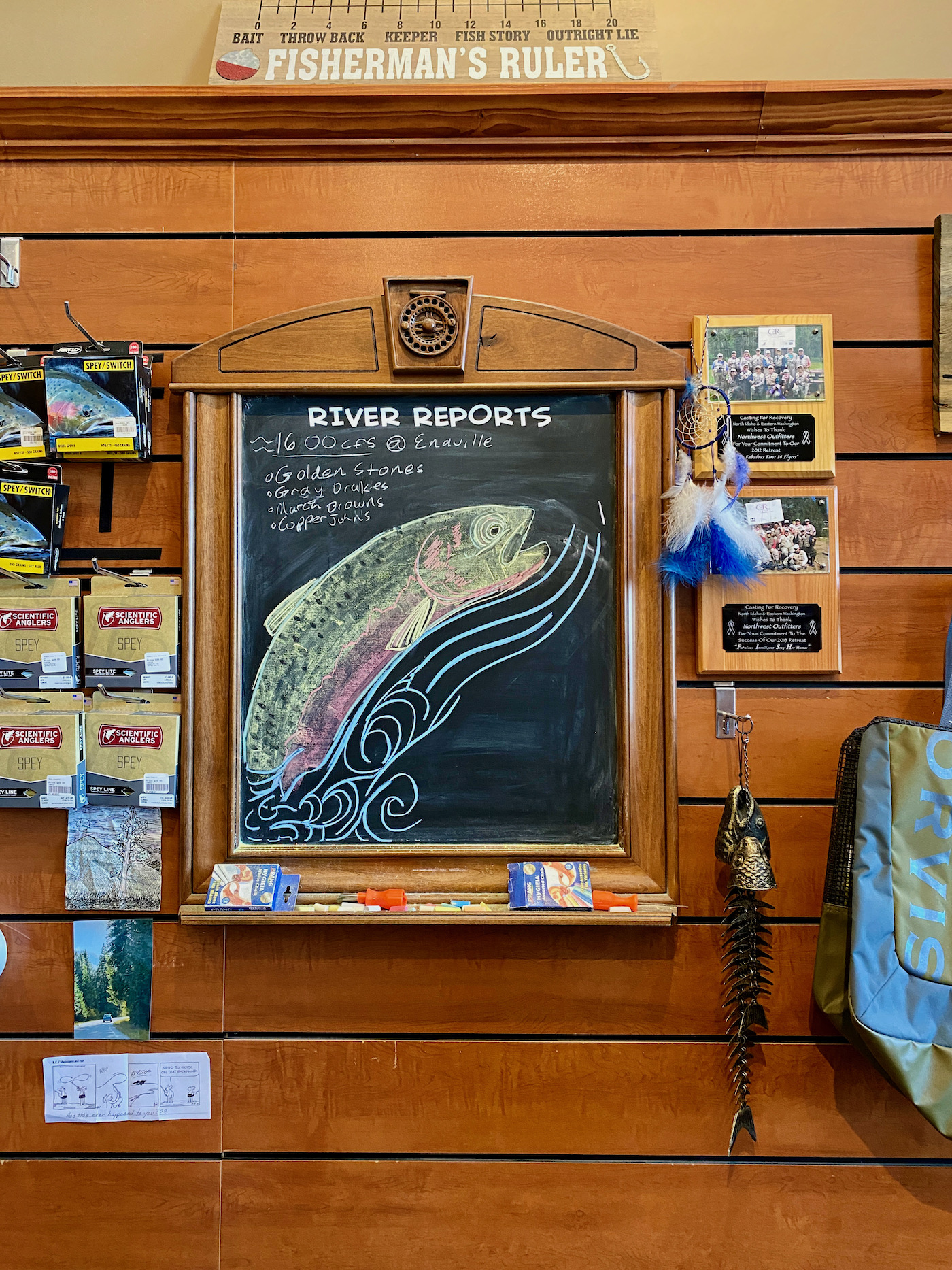 River report sign in a fly fishing shop with a chalk drawn trout