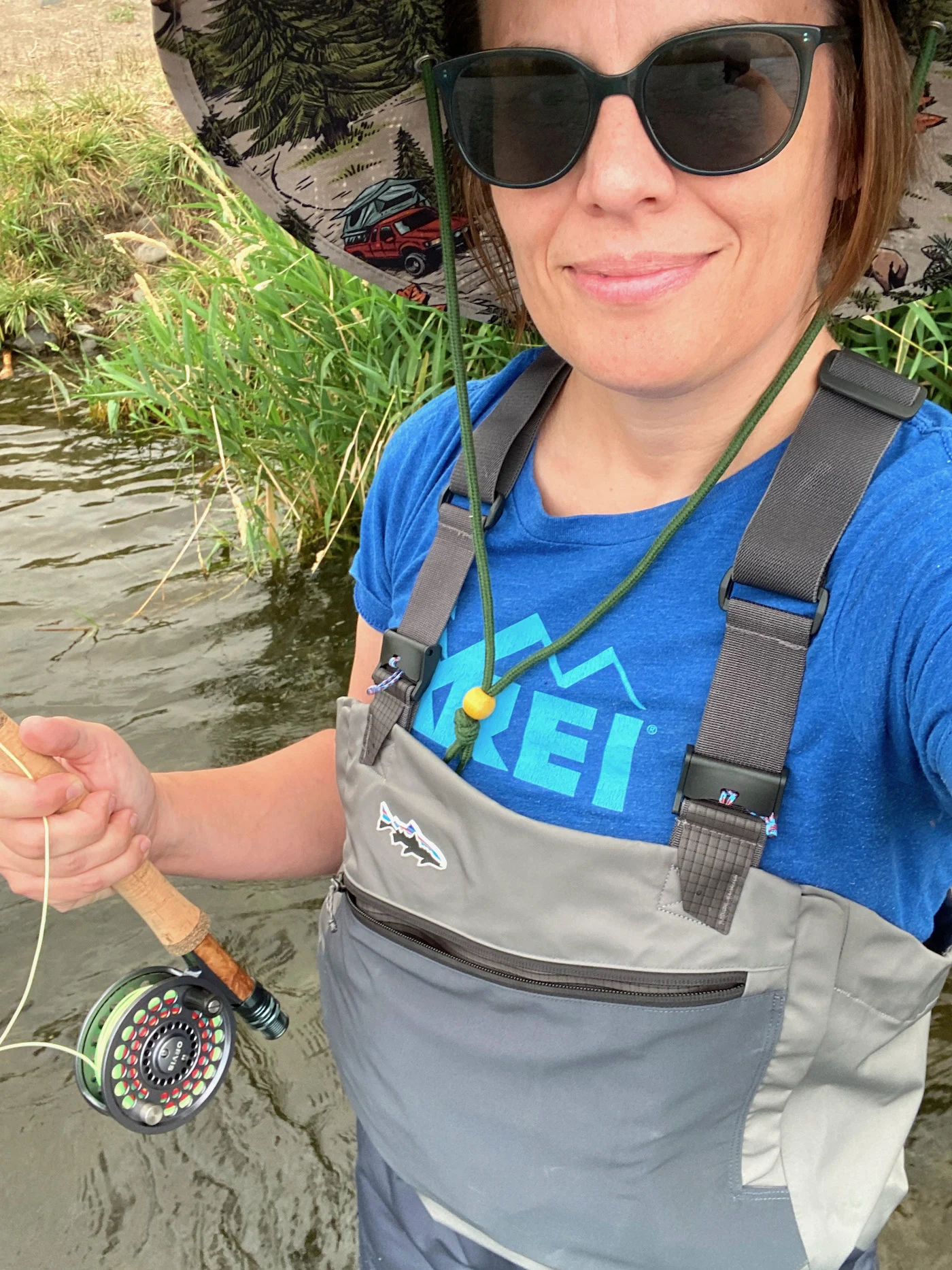 Woman-wearing-fly-fishing-waders-holding-a-rod