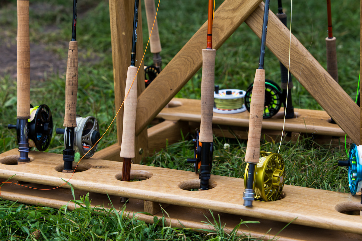 Fly-fishing-rods-standing-up-in-a-wooden-holde