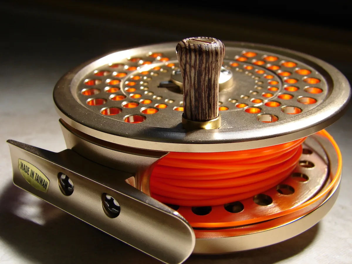 Gold-fly-fishing-reel-with-orange-line-attached
