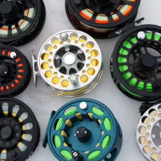 Several-fly-reels-laying-on-a-surface
