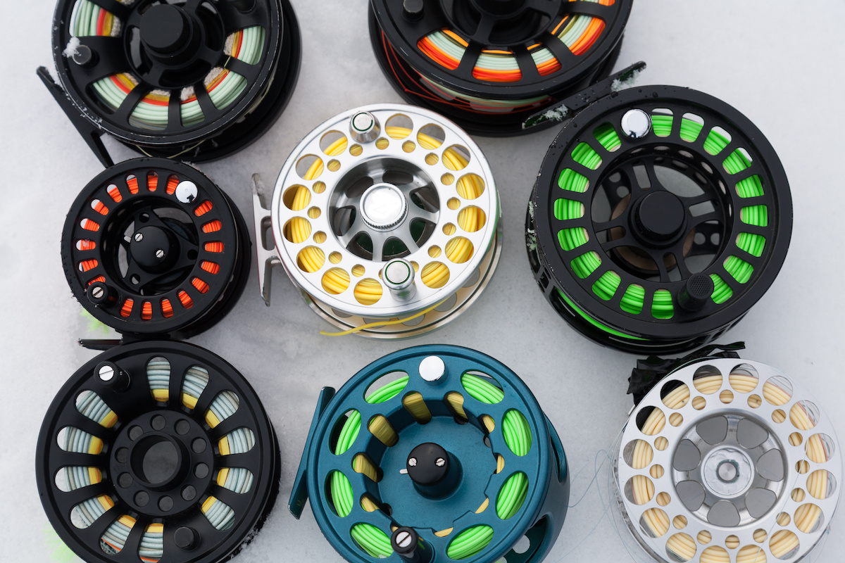 Several-fly-reels-laying-on-a-surface