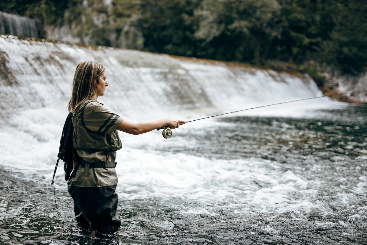 Woman-fly-fishing-in-a-river-with-a-small-rod