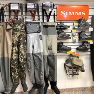 Fly fishing store display of fishing waders and wading boots