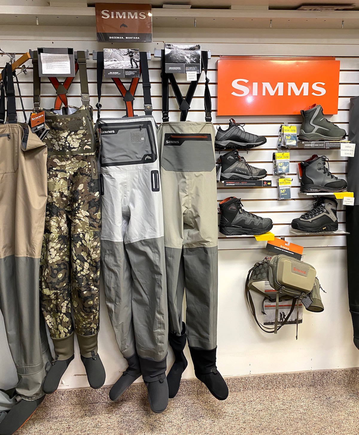 https://rodandreelflyfishing.com/wp-content/uploads/2021/11/Fly-fishing-store-display-of-fishing-waders-and-wading-boots.jpeg