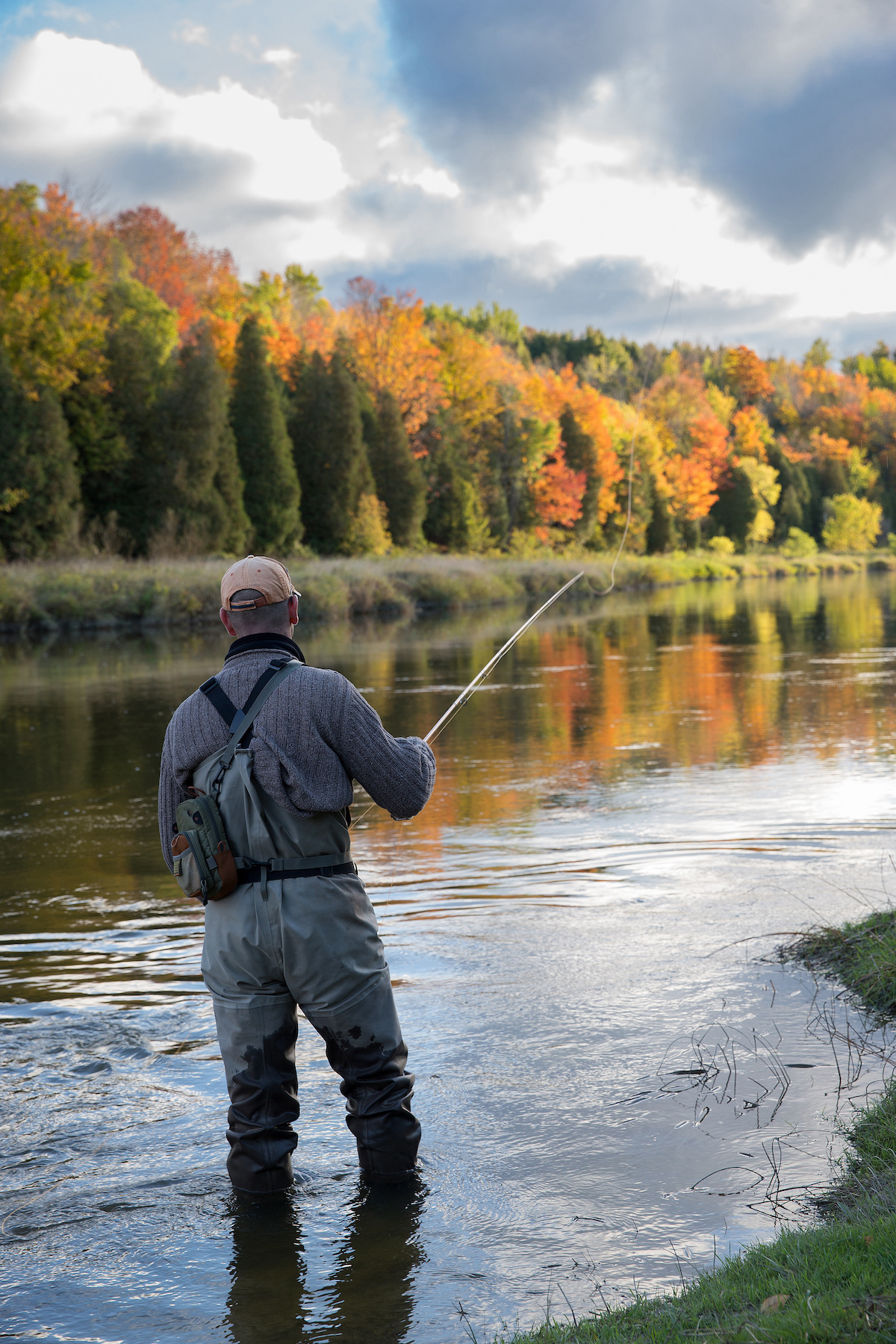 Man fly fishing in the fall in a river